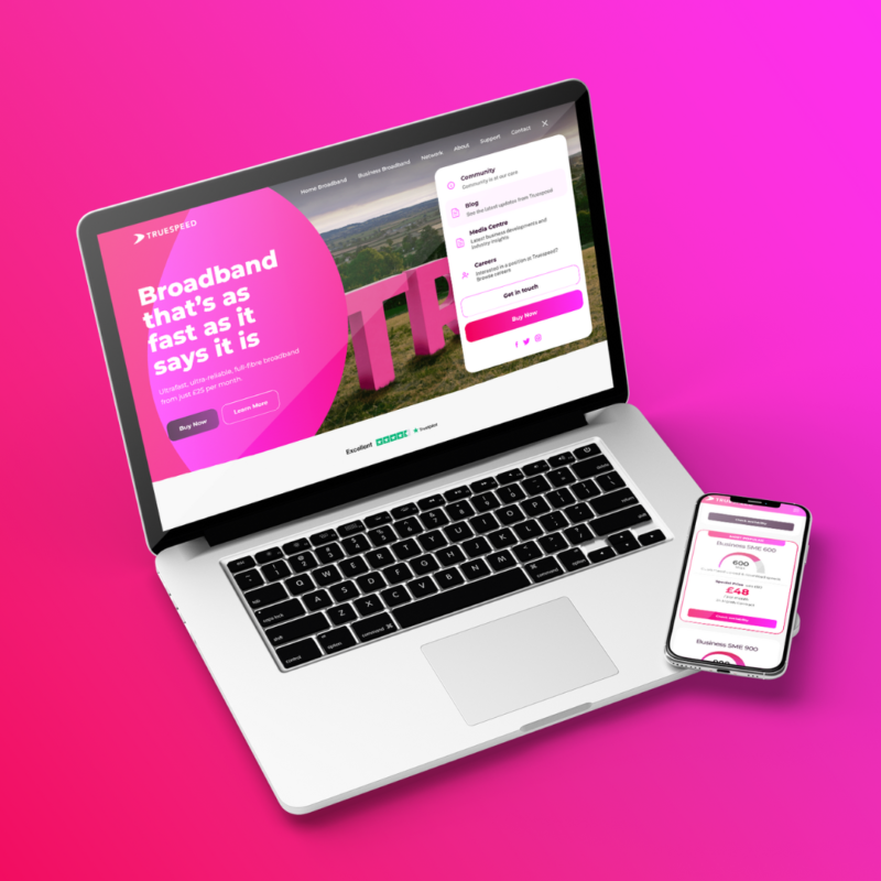 A laptop and smartphone displaying a broadband provider website with bright pink branding, featuring a call to action about fast broadband, pricing information, and a navigation menu, all set on a vivid pink gradient background.