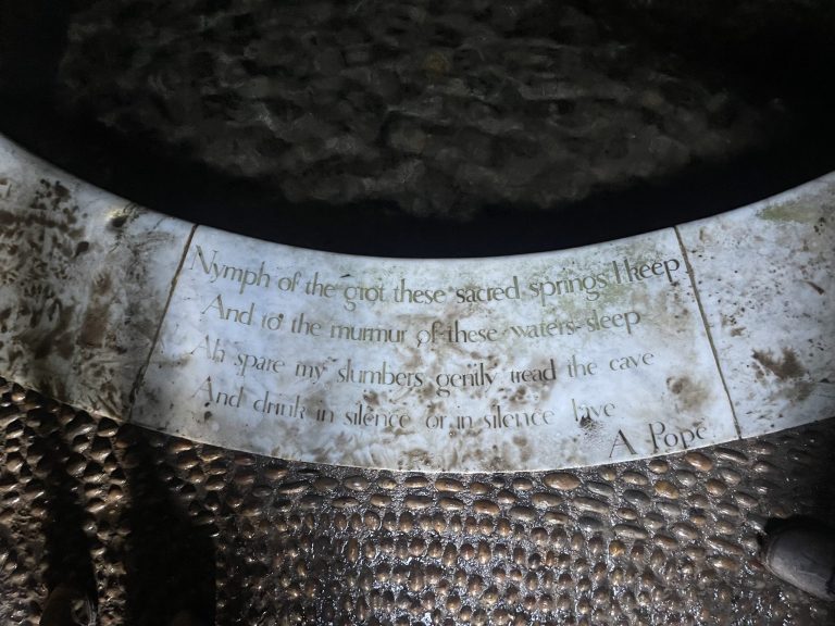 Close-up of embossed metallic surface with partially readable text.