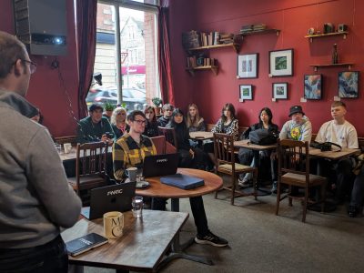 People sitting in a cosy room watching a presentation