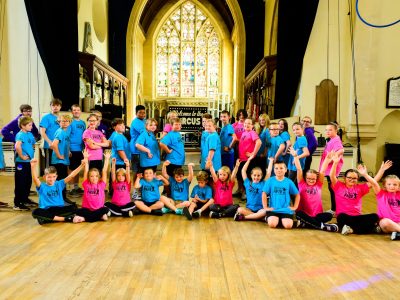 A group of children all gathered in a church hall