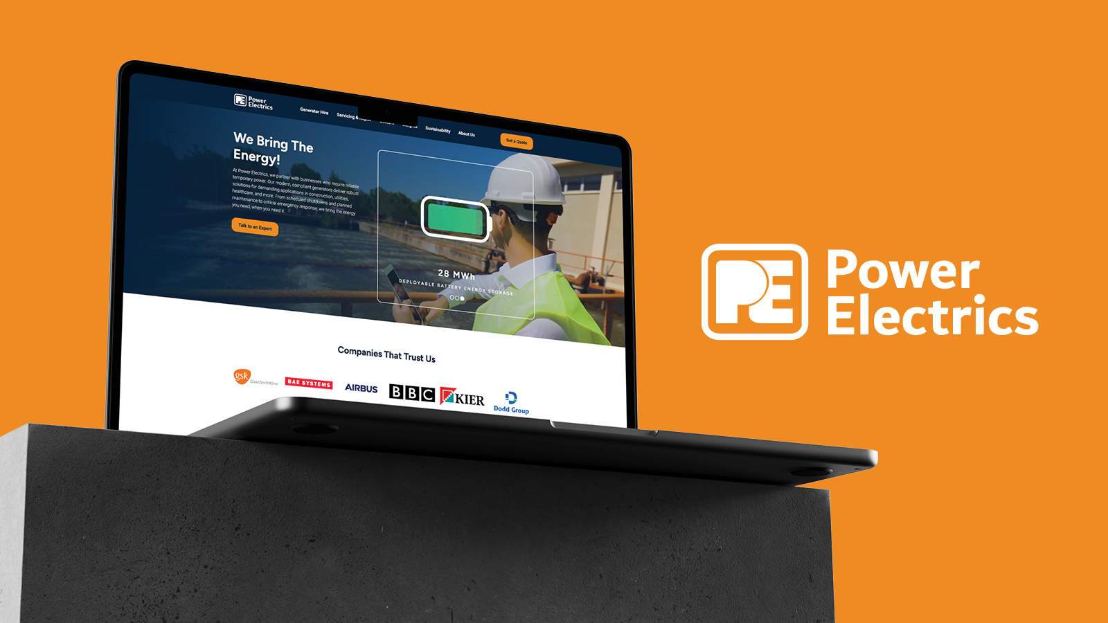 Power Electrics website shown on a laptop sat on a concrete block