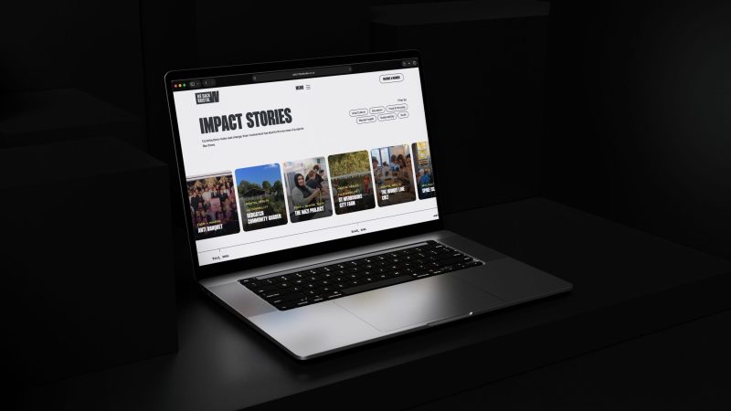 Laptop displaying impact stories page of website